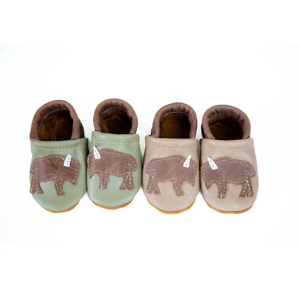 white background with two pair of handmade leather baby shoes with western buffalo patches created by starry night design 