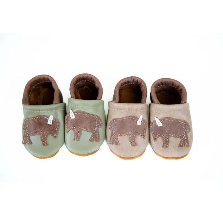 white background with two pair of handmade leather baby shoes with western buffalo patches created by starry night design 