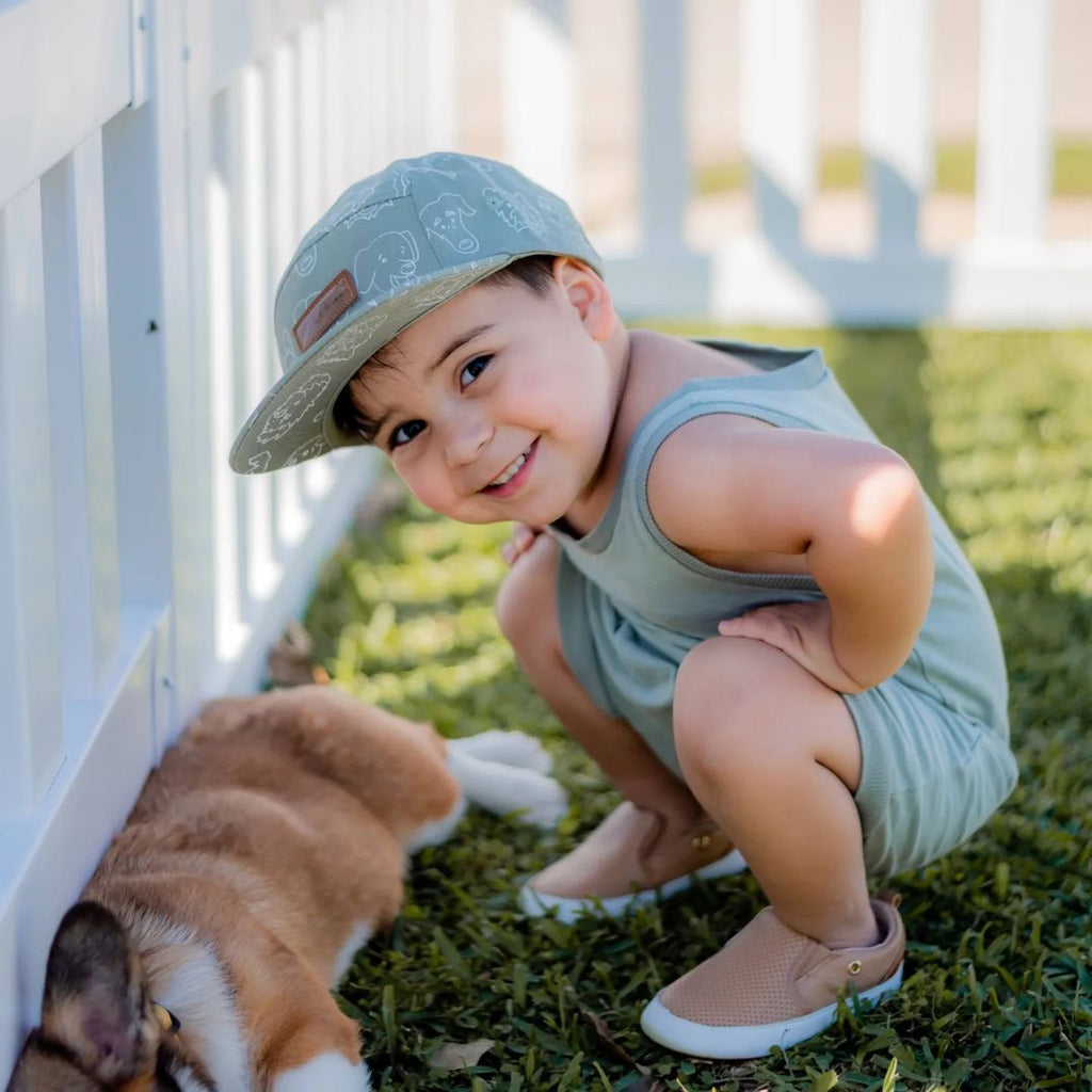 Little boy wearing the Little Love Bug company tan quinn shoes.