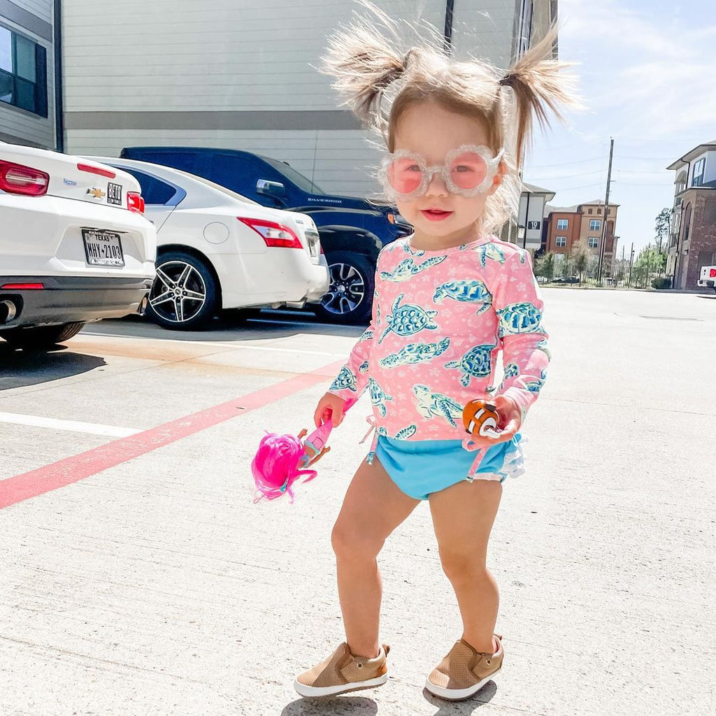 Girl wearing the tan quinn little love bug co shoes