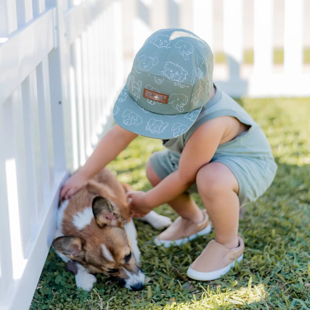 Boy petting a dog while wearing anti-slip Little Love Bug Tan Quinn shoes