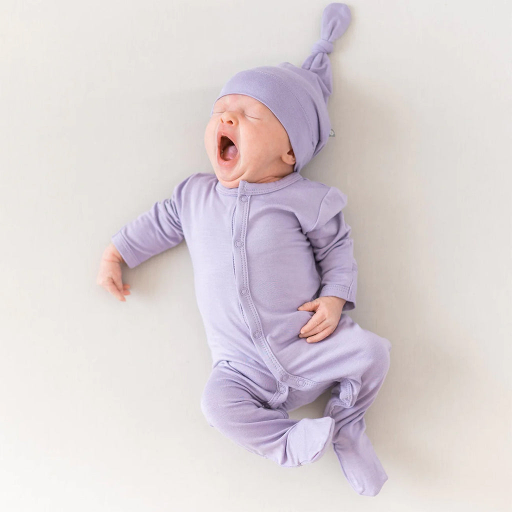 baby yawning while wearing KyteBaby baby hat
