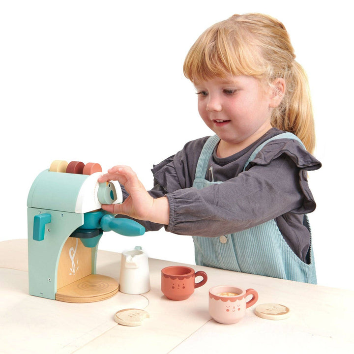 child playing with kids pretend play esspresso machine with included pucks and milk frother 