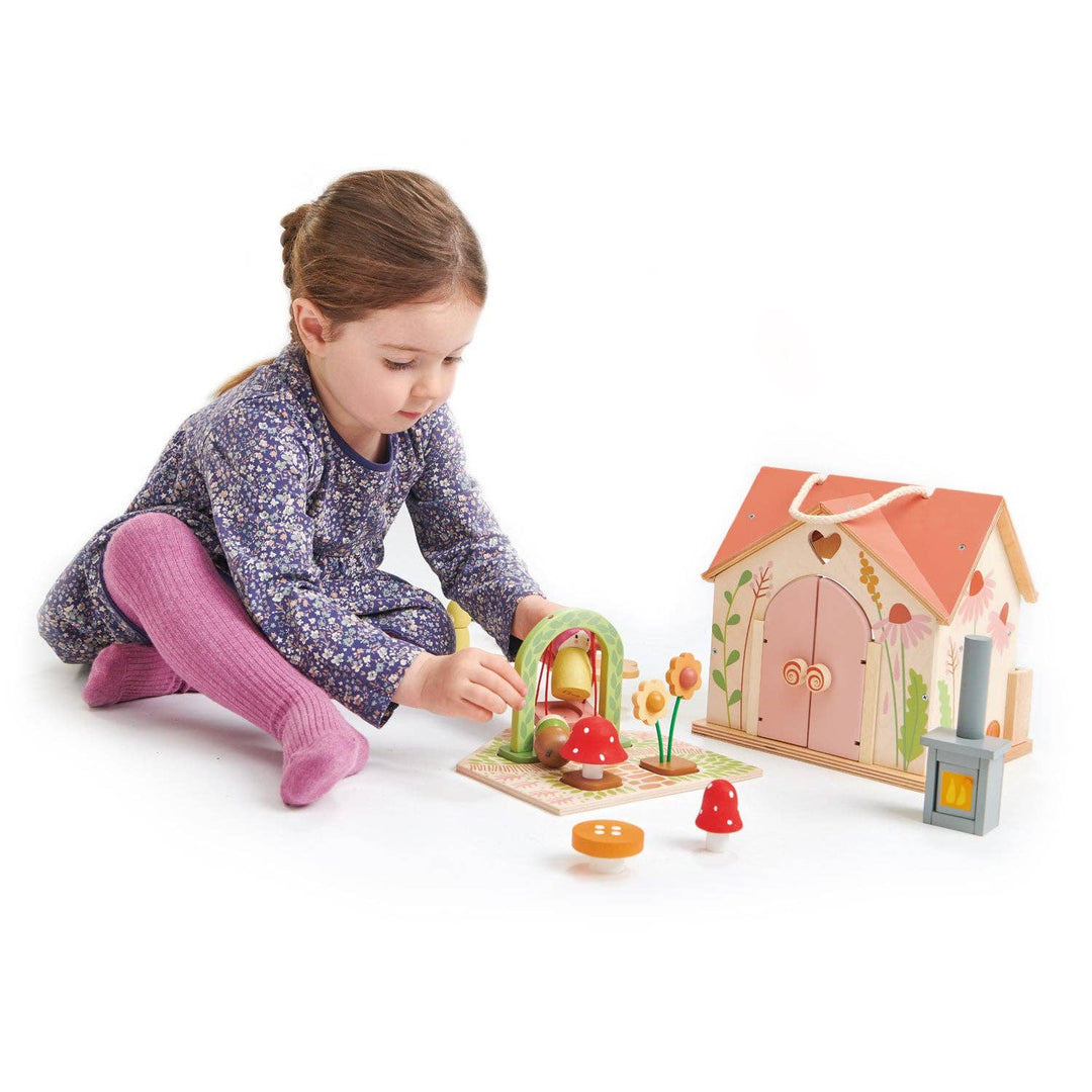 child playing with tender leaf toys wooden rosewood cottage included garden and dolls  