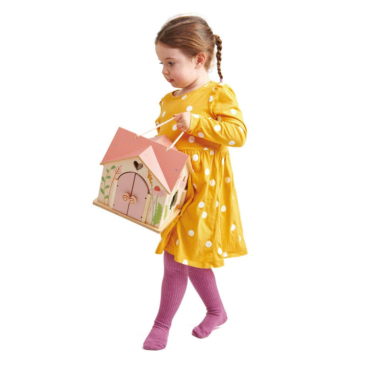 little girl holding handpainted tenderleaf rosewood cottage doll house 