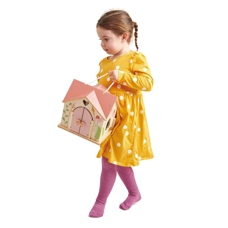 little girl holding handpainted tenderleaf rosewood cottage doll house 