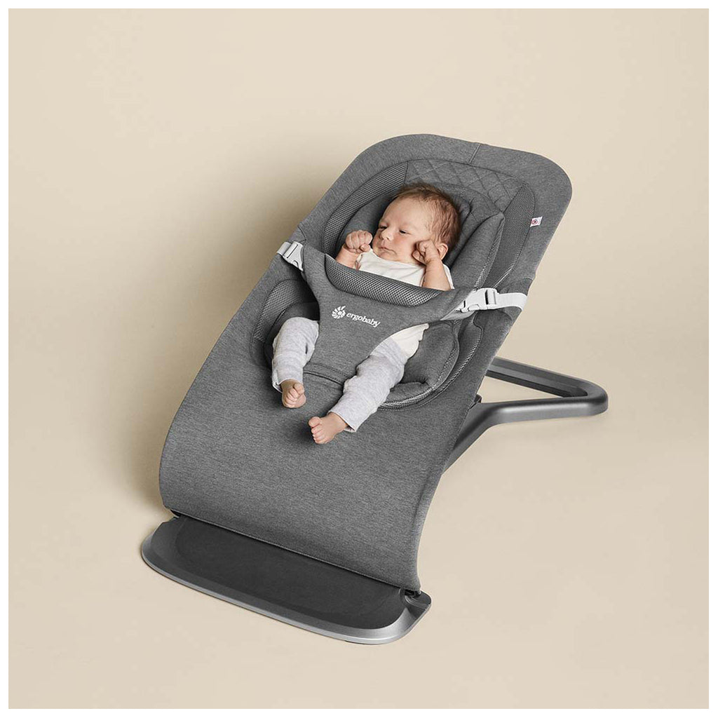 Newborn in the ergobaby bouncer in charcoal