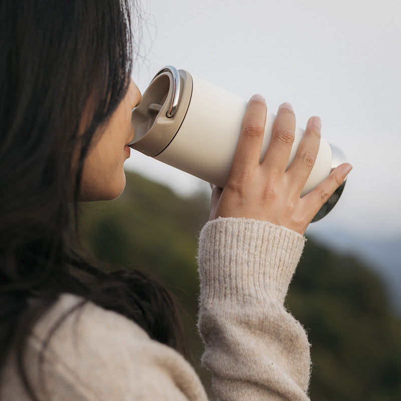 Woman drinking from Tofu Klean Kanteen 12oz TKWide with Cafe Cap, chip resistant finish for durability.