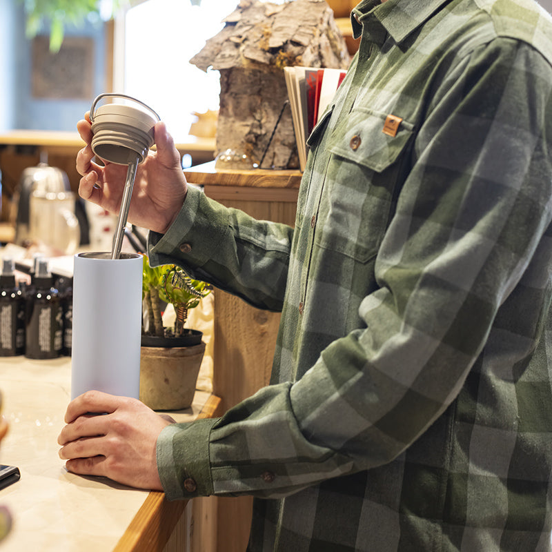 Coffee shop scene with Klean Kanteen 20oz TKWide with Twist Cap in Copper, sealed no leak top for safe sipping.