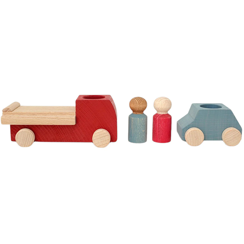 A child setting up a pretend pizza delivery scenario with the Candylab Toys pizza van, interacting with other wooden toy cars.