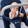 Baby playing with  the Ergo baby bouncer toy bar