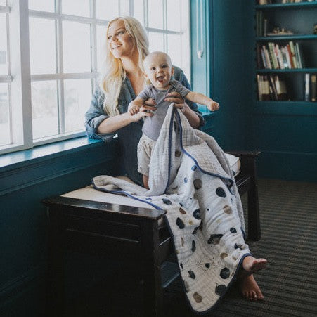 Soft Little Unicorn Original Cotton Muslin Quilt - Planetary styled on a crib, part of the brand’s premium baby quilts collection.