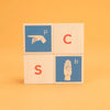 Four American Sign Language blocks stacked two-by-two, spelling out pcsb. 