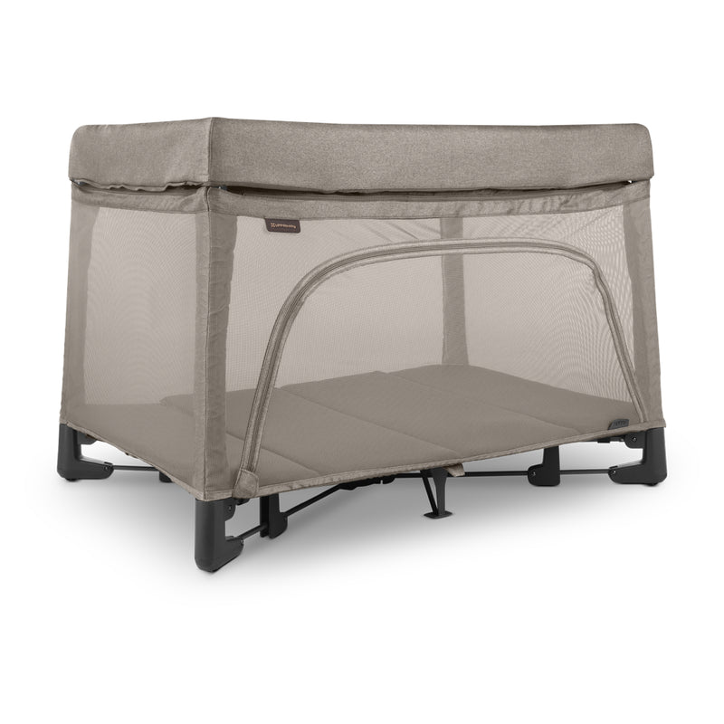 Uppababy Remi travel playard in Wells, a beige-toned fabric. Lightweight and portable, ideal for families seeking the best playards for travel.