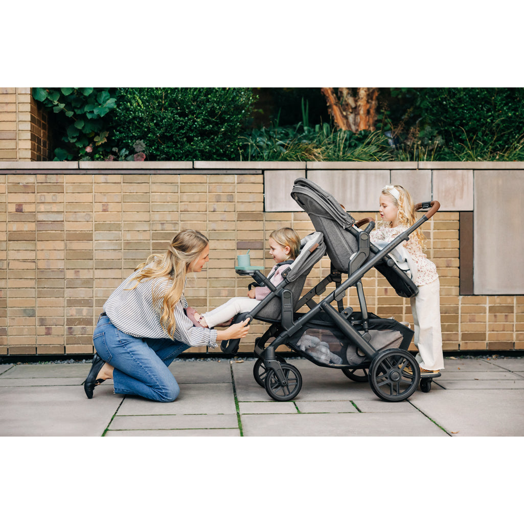 Street scene with UPPAbaby Vista V3 Twin Double Stroller in use, perfect lightweight stroller for urban travel