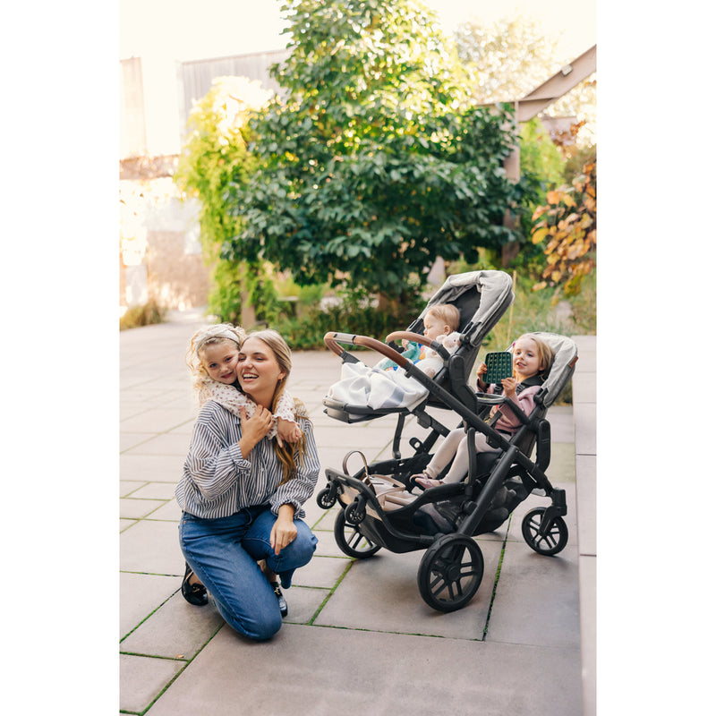 Family using the UPPAbaby Vista V3 Twin Double Stroller with rumbleseat and bassinet combo, smart double stroller option