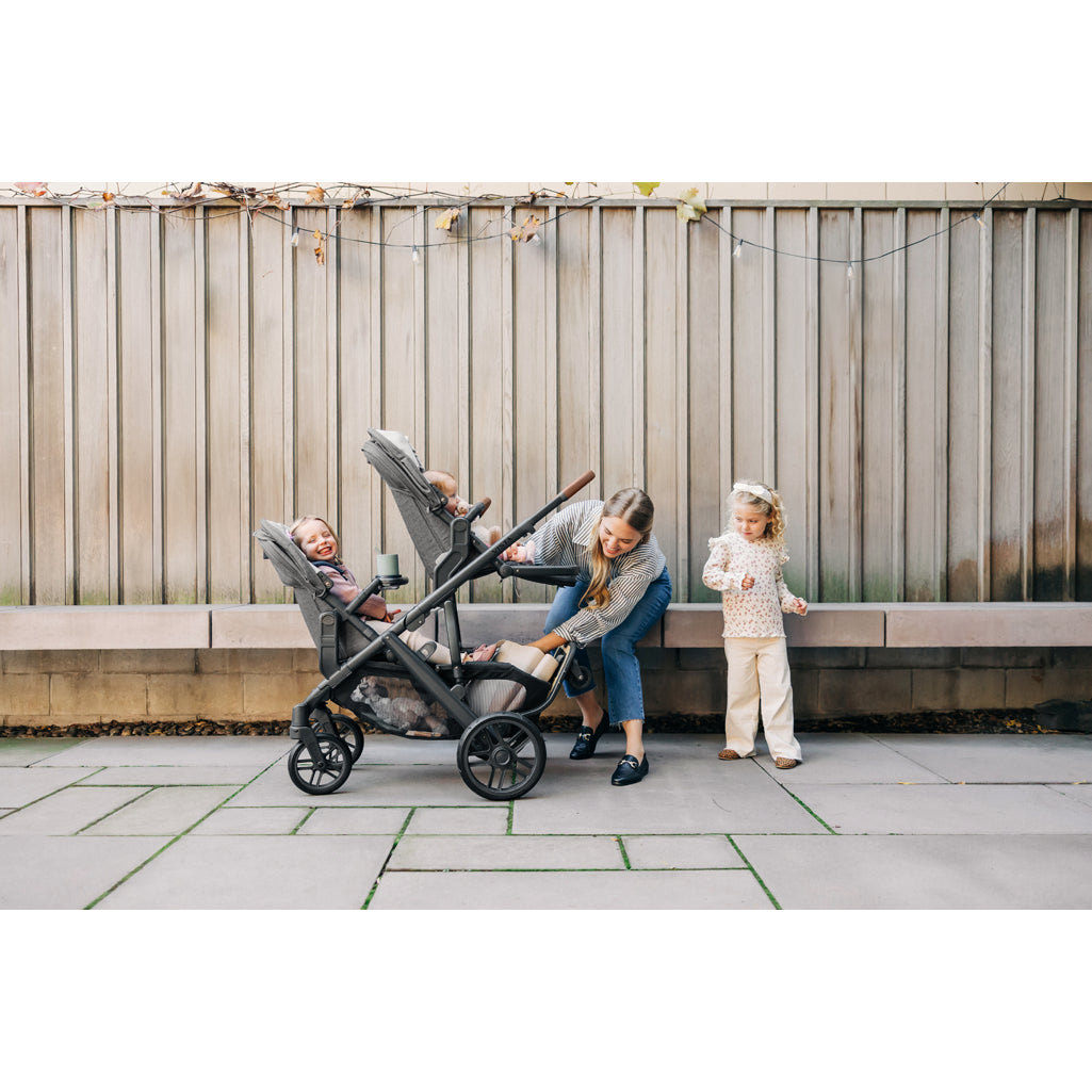 Twins in UPPAbaby Vista V3 Twin Double Stroller, one in bassinet, one in toddler seat, a practical rumbleseat combo