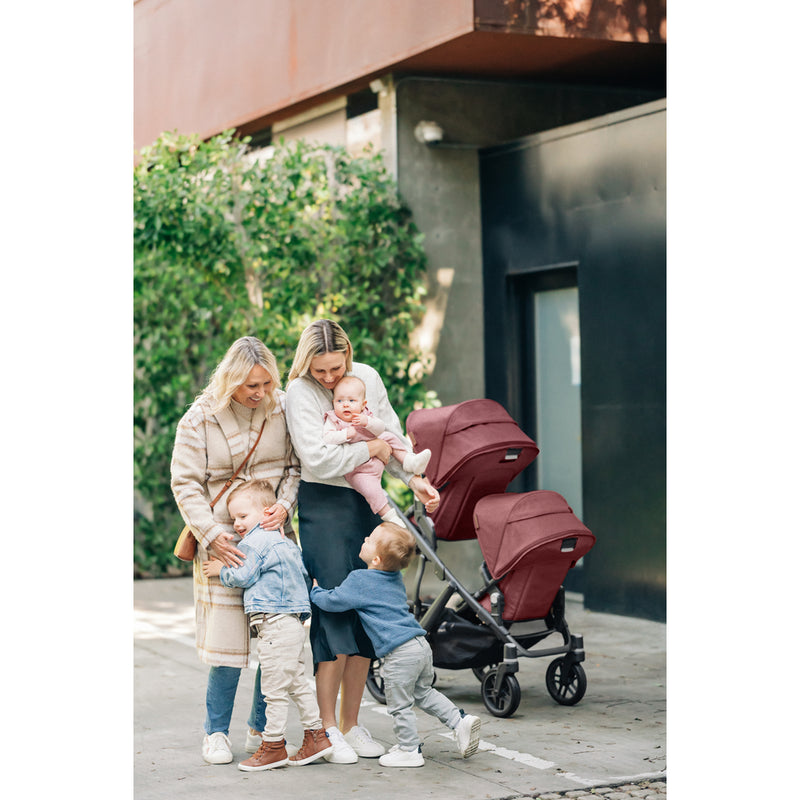 Parents strolling with the UPPAbaby Vista V3 Twin Double Stroller in Jake, a durable double stroller for everyday use
