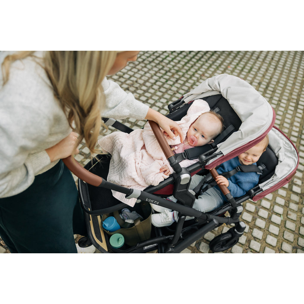 On the go with the UPPAbaby Vista V3 Twin Double Stroller in Greyson, ideal as a lightweight stroller for urban families