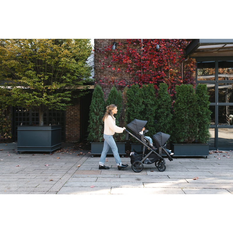 Relaxing stroll using the UPPAbaby Vista V3 Twin Double Stroller in Declan, a smart stroller travel system for growing families