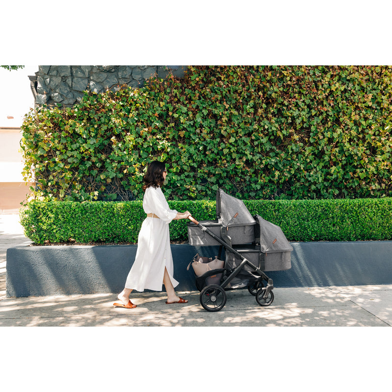 UPPAbaby Vista V3 Twin Double Stroller in Declan being pushed outdoors, highlights a convenient rumbleseat configuration