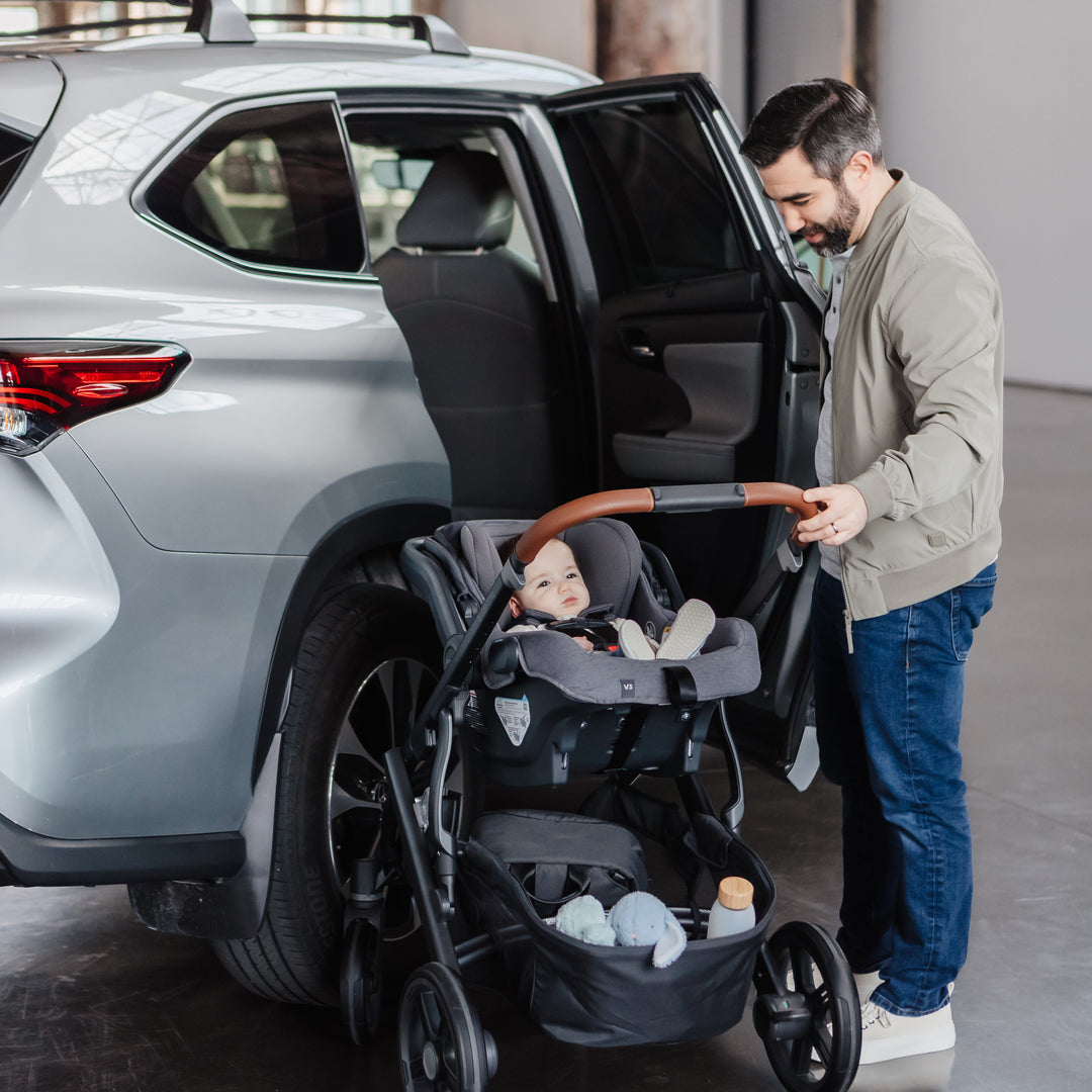 Man opening car door to uppababy vista v3 baby stroller with baby on the mesa v3