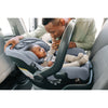 Cute baby sitting rear facing in the Mesa V2 infant carseat.