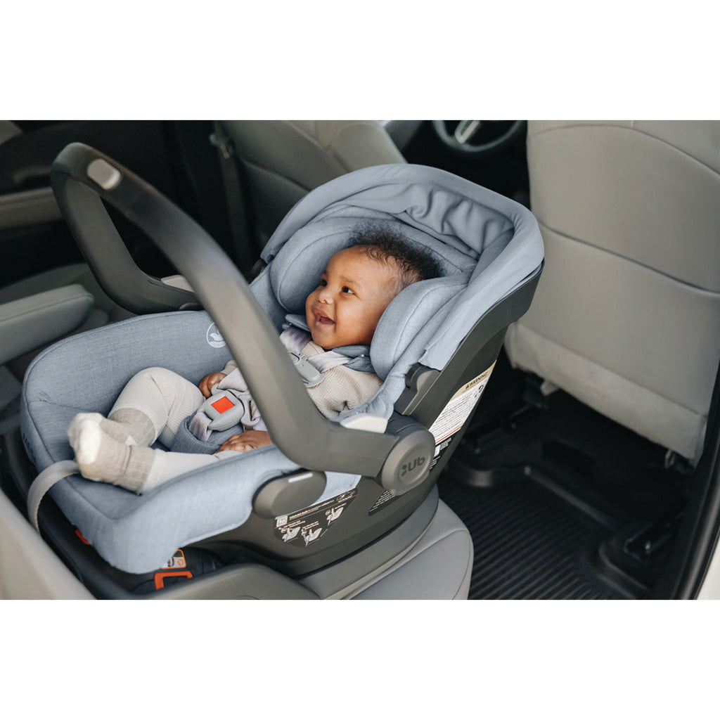 An adorable smiling baby in the Mesa v2 car seat in Gregory.