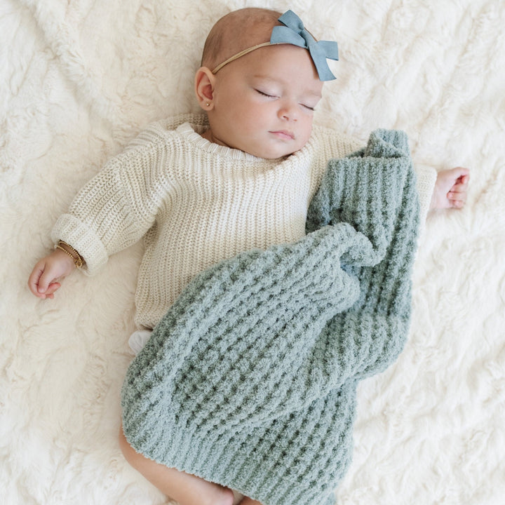 The Saranoni Waffle Knit Mini Blanket in Elm feels airy and buttery soft, perfect for Soft baby blankets needs.