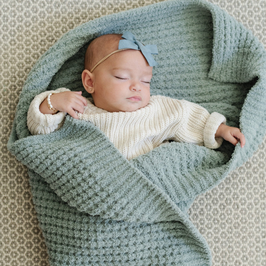 Wrap and cuddle with the Elm Saranoni Waffle Knit Receiving Blanket, a soft baby blanket option.