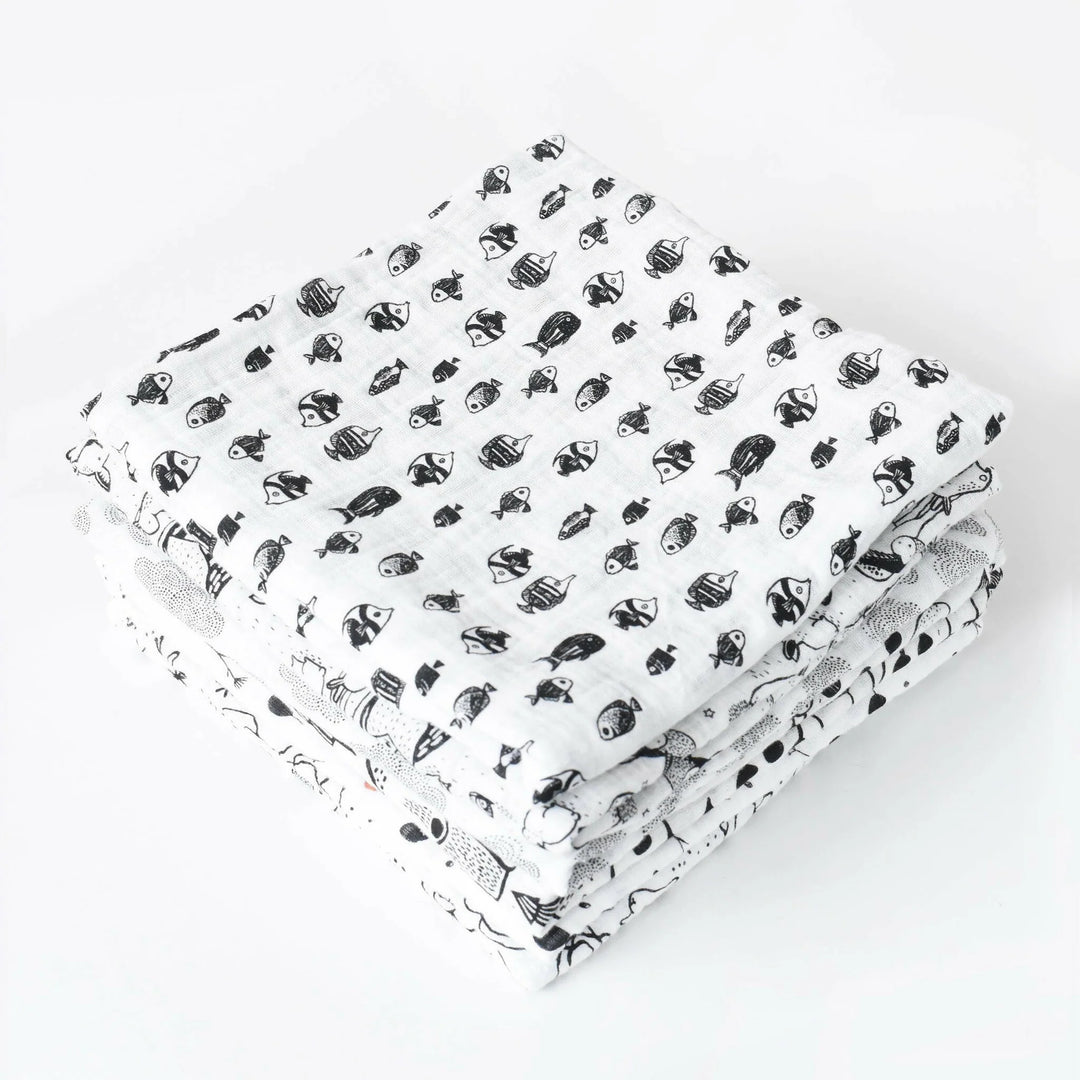 Wee Gallery Organic Muslin Swaddle in Fish, folded high contrast black and white baby blankets in soft organic cotton