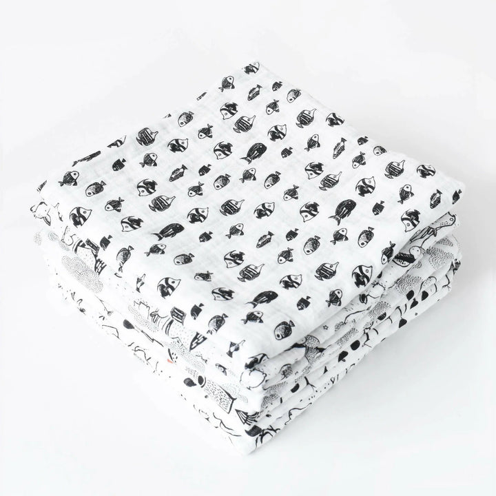Wee Gallery Organic Muslin Swaddle in Fish, folded high contrast black and white baby blankets in soft organic cotton