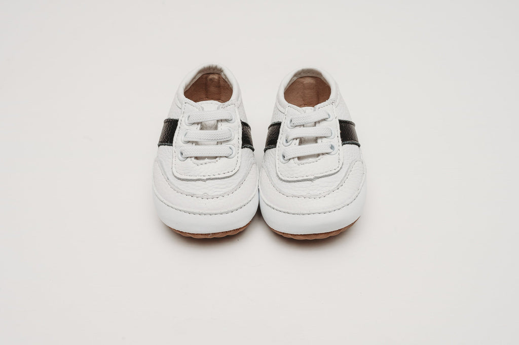 Close up of the White and black little love bug sneakers.