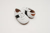 White and black little love bug sneakers.