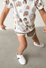 Boy dancing in the Little Love Bug white and black sneakers.