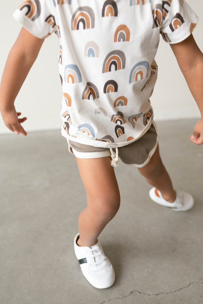 Boy dancing in the Little Love Bug white and black sneakers.