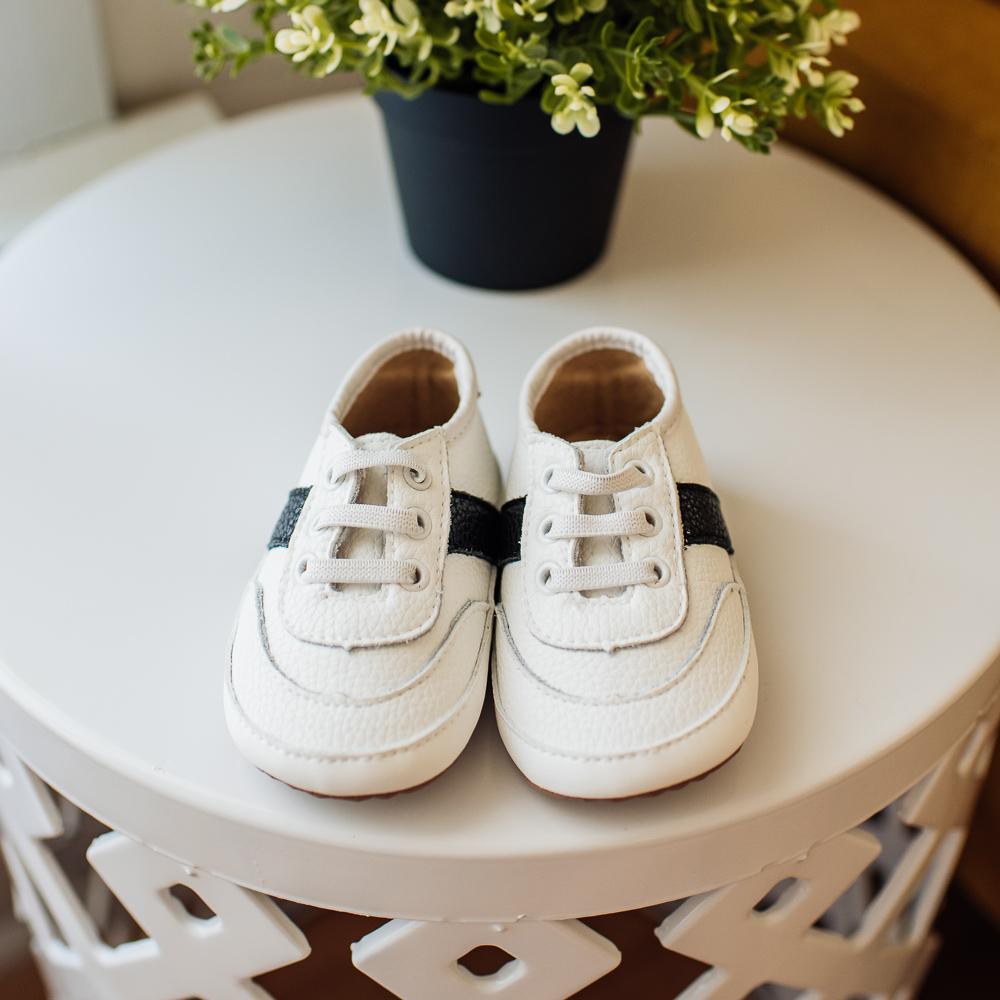 White and black little love bug sneakers.