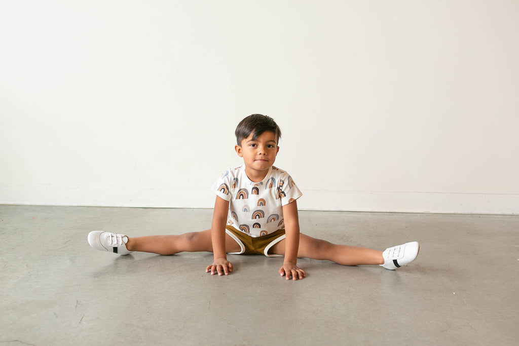 Boy wearing white and black little love bug sneakers