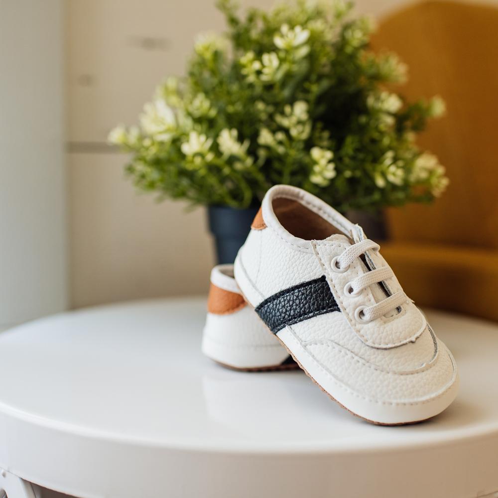 White and black little love bug sneakers.