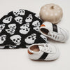 White and black leather little love bug sneakers.