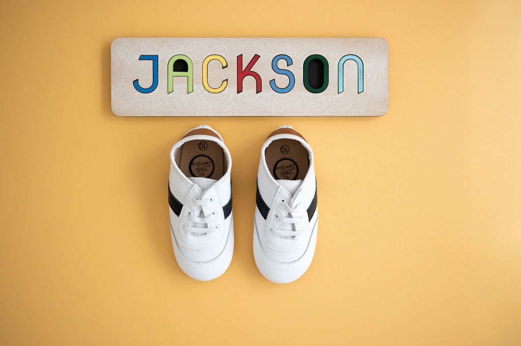 White and black little love bug sneakers.