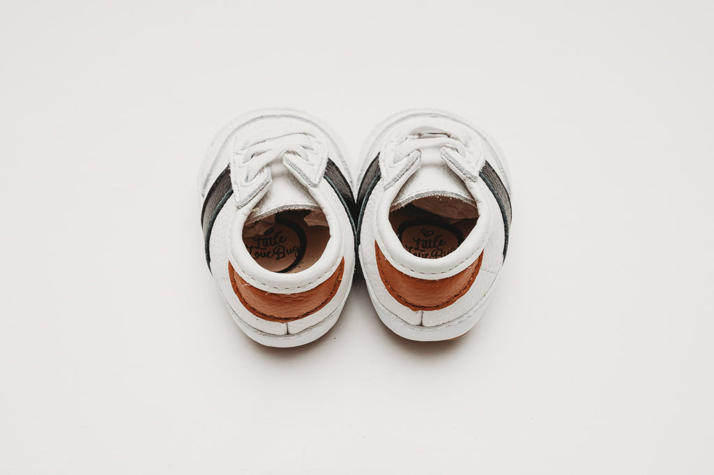 White and black little love bug sneakers.