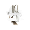 Close up of the white natural stokke Nomi high chair set.