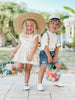 Toddlers wearing little love bug co white leather shoes