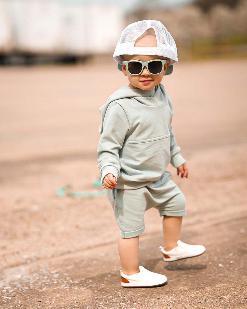 Toddler boy wearing the White Quinn leather Little Love Bug shoes.