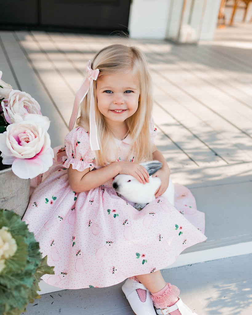 girl holding a bunny while wearing the t-bar white leather shoes, made by  Little Love Bug Co.