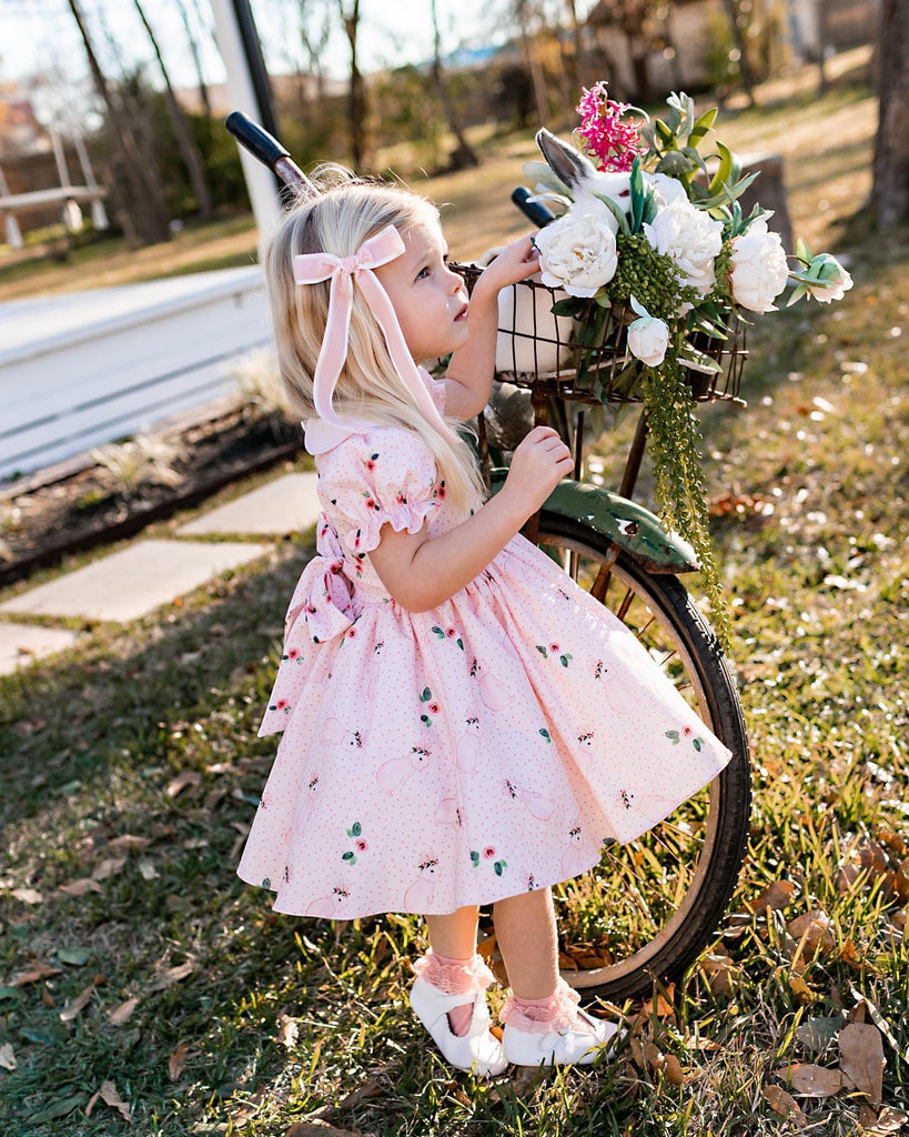 Girl in dress wearing the  Little Love Bug Co. white leather shoes.