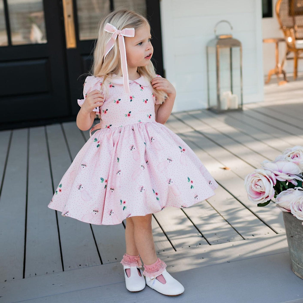 Little girl in white T-Bar little love bug shoes.