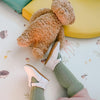 Toddler wearing green socks and white anti slip t-bar little love bug co. shoes.