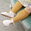 Girl wearing yellow socks and white t-bar leather shoes by Little Love Bug Co.